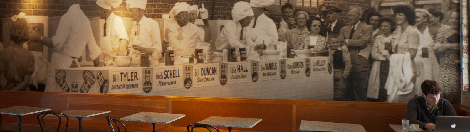 Interior of Seven Stars Bakery wall showing an old black and white photo of bakers in a line.
